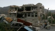 A man rides a motorbike past a house destroyed during recent battles between Houthi fighters and pro-government fighters in the southwestern city of Taiz, Yemen November 18, 2016. REUTERS/Anees Mahyoub
