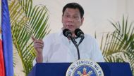 Philippine President Rodrigo Duterte gestures as he delivers a speech, prior to his departure for the APEC summit in Peru, at Davo airport, in southern island of Mindanao on November 17, 2016. AFP / MANMAN DEJETO