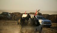 Military vehicle of Shi'ite fighters drive during a battle with Islamic State militants at the airport of Tal Afar west of Mosul, Iraq November 18, 2016. REUTERS/Thaier Al-Sudani