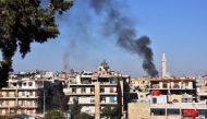 Smoke billows in the government-held side of west Aleppo, on November 20, 2016, following reported rocket fire by the opposition forces that hold the eastern part of the city. AFP / GEORGE OURFALIAN