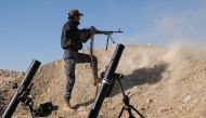 A member of the Iraqi Federal Police fires his weapon at an Islamic State (IS) group target on the front line near the village of Tall Adh-Dhahab, some 10 kilometres (6 miles) south of Mosul, on November 18, during a massive operation to oust IS jihadists