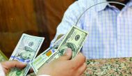 A customer exchanges US dollars to Egyptian pounds in a foreign exchange office in central Cairo. 