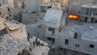 Search and rescue team members work at the scene of the air strikes carried out by the war crafts belonging to Assad regime forces on the opposition-controlled Al Moyaser neighbourhood of Aleppo, Syria on November 22, 2016.( ?brahim Ebu Leys - Anadolu Age