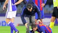 Medics assist Barcelona's defender Jordi Alba during the Spanish league football match Real Sociedad vs FC Barcelona at the Anoeta stadium in San Sebastian, on November 27, 2016. / AFP / ANDER GILLENEA
