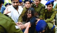 Indian police personnel detain an activist from the Congress Party student wing during a protest against demonetisation in New Delhi on November 28, 2016. Tens of thousands of people turned out November 28 for nationwide protests against India's controver