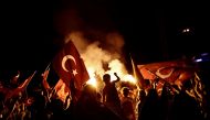 Pro-Erdogan supporters wave Turkish national flags during a rally at Taksim square in Istanbul on July 18, 2016 following the military failed coup attempt of July 15. Turkish security forces on July 18 carried out new raids against suspected plotters of t