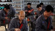 North Korean workers make soccer shoes inside a temporary factory at a rural village on the edge of Dandong October 24, 2012. Reuters/Aly Song/File Photo
