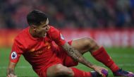 Liverpool's Brazilian midfielder Philippe Coutinho holds his foot as he lies on the pitch injured during the English Premier League football match between Liverpool and Sunderland at Anfield in Liverpool, north west England on November 26, 2016. AFP / Pau