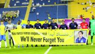 Players pay tribute to the former Al Gharafa head coach Caio Junior who died following the aeroplane disaster that took the lives of 77 people in Colombia, prior to their Qatar Stars League match at the Al Gharafa Stadium yesterday.
