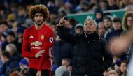 Manchester United's Marouane Fellaini prepares to come on as a substitute as manager Jose Mourinho looks on Reuters / Andrew Yates 
