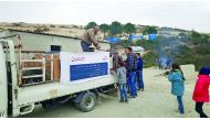 A Qatar Charity vehicle distributing winter provisions to Syrian refugees in Lebanon. 