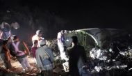 Pakistani residents stand beside the wreckage of the crashed PIA passenger plane Flight PK661 at the site in the village of Saddha Batolni in the Abbottabad district of Khyber Pakhtunkhwa province on December 7, 2016. AFP / AAMIR QURESHI