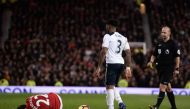 Manchester United's Armenian midfielder Henrikh Mkhitaryan (L) lies injured after a challenge by Tottenham Hotspur's English defender Danny Rose during the English Premier League football match between Manchester United and Tottenham Hotspur at Old Traffo