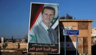 A picture of Syria's President Bashar al-Assad is seen in Ramouseh, a government controlled area of Aleppo, Syria December 8, 2016. REUTERS/Omar Sanadiki