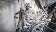Civilians run around the debris of damaged buildings after the war crafts belonging to the Assad Regime's and Russian forces' airstrikes over residential areas at Firdevs neighborhood in Aleppo, Syria on November 17, 2016.  ( Jawad al Rifai - Anadolu Agen