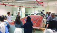 Tatiana, one of the textile conservators, explains the conservation process for a Turkish Ushak carpet dating to between late 15th to early 16th century at the MIA Conservation Laboratory, yesterday.