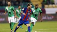 Barcelona's Lionel Messi fights for the ball with Saudi Arabia's Al-Ahli Luiz Carlos. REUTERS/Ibraheem Al Omari
