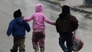 Children walk together as they flee deeper into the remaining rebel-held areas of Aleppo, Syria December 13, 2016. REUTERS/Abdalrhman Ismail 