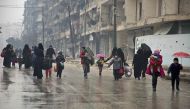 Syrians leave a rebel-held area of Aleppo towards the government-held side on December 13, 2016 during an operation by Syrian government forces to retake the embattled city. AFP / KARAM AL-MASRI
