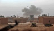 Smoke rises from the village of Shwah, south of the city of Tal Afar on the western outskirts of Mosul, on December 13, 2016, as Shiite fighters from the Hashed al-Shaabi (Popular Mobilisation) paramilitary units advance towards the village during an ongo