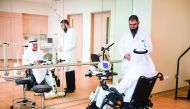 Physical therapist Basem Owais conducts a session in the QRI gymnasium with patient Jassim Mohammed Ali Abdulla.