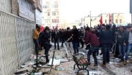 This picture obtained from Dogan News Agency shows people protesting in front of the offices of pro-Kurdish Peoples' Democratic Party (HDP) following a suicide car bombing on December 17, 2016 in Kayseri. Thirteen Turkish soldiers were killed and dozens m