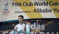 Real Madrid's forward Cristiano Ronaldo poses as he holds the Golden Ball trophy after winning the Club World Cup football final match between Kashima Antlers of Japan and Real Madrid of Spain at Yokohama International stadium in Yokohama on December 18, 