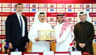 CEO of QSL, Hani Taleb Ballan (second right), presenting a memento to AAB Toyota Chairman, Osama Abdullah Abdulghani, as AAB Toyota CEO, Serdar Toktamis (left), and QSL Executive Director for Marketing and Communications, Khalifa Saleh Al Haroon (right) s