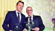 Qatar Airways Vice-President of the Americas, Gunter Saurwein (left) receiving the awards on behalf of the airline. Also seen is American comedian, Mack Dryden.