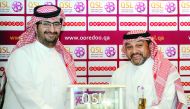 Sheikh Ali bin Jabor Al Thani, CLRO, Ooredoo Qatar, and Hani Ballan, Chief Executive Officer, Qatar Stars League, exchanging documents after signing the agreement.