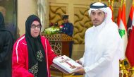 Prime Minister and Interior Minister H E Sheikh Abdullah bin Nasser bin Khalifa Al Thani honouring Sarah Masoud, who won the silver medal in the Women's Shotput F33 event in Paralympic Games in Rio de Janeiro, Brazil, during the 41st General Assembly of t
