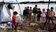MOSUL, IRAQ - DECEMBER 21: Iraqi kids are seen around the burned tent after fire breaks out at the Khazir refugee camp where Internally relocated Iraqi people, in the Hasan Sam village near Mosul, Iraq on December 21, 2016. (Hamit Hüseyin - Anadolu Agency