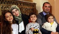 Syrian girl Bana al-Abed (L), known as Aleppo's tweeting girl, poses with her family, her mother Fatemah, her father Ghassan and her brothers Nour (C) and Laith (R) during an interview in Ankara, Turkey, on December 22, 2016. The young Syrian girl was one
