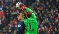 Leipzig's Yussuf Poulsen (left) and Bayern Munich's goalkeeper Manuel Neuer vie for the ball possession during their Bundesliga match at Allianz Arena in Munich, Germany, on Wednesday. 