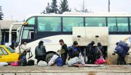 Syrian rebel fighters arrive in the opposition-controlled Khan Al Assal region, west of Aleppo, after being evacuated from the embattled city, yesterday.