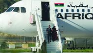 A crew member helping a hostage to disembark from the Afriqiyah Airways A320 after it was hijacked from Libya, in Valletta, Malta, yesterday.