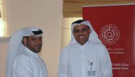 Abdulla Al Mansoori, Director of QCDC, hands out a completion certificate to one of the participants. 
