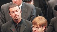 (FILES): This file photo taken on September 6, 1997 shows pop stars George Michael (L) and Elton John (R) leaving Westminster Abbey following the funeral service of Diana, Princess of Wales.  AFP / JOHNNY EGGITT
