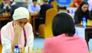Zu Chen (left)  of Qatar pondering her next move at the Qatar Rapid and Blitz Championships, at the Ali Bin Hamad Attiya Arena, Al Sadd, in Doha yesterday.