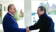 Turkish Foreign Minister Mevlut Cavusoglu (left) welcomes Turkish Republic of Northern Cyprus (TRNC) Foreign Minister Tahsin Ertugruloglu prior to their meeting in Ankara, Turkey, yesterday. 