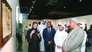 Qatari artist Jameela Al Ansari (left) explains one of her paintings to Katara General Manager Dr Khalid bin Ibrahim Al Sulaiti (second right) and other officials at the opening of 'Salam' exhibition on Tuesday at Katara. 