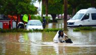 A woman wades through floodwater after a heavy rainfall hit Mersin, Turkey, yesterday.