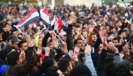 Supporters of  Muqtada Al Sadr chant slogans during a demonstration against corruption and demanding reforms, in Baghdad, Iraq, yesterday.