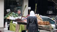 A Syrian woman shops for vegetables for in Aleppo's government controlled Al-Jamiliyah neighbourhood on December 31, 2016. / AFP / George OURFALIAN