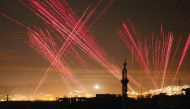 Lights illuminate the sky after regime forces fire into the air during New Year’s celebrations in Damascus, Syria.
