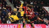 Arsenal's French striker Olivier Giroud (L) fails to connect with this overhead shot during the English Premier League football match between Bournemouth and Arsenal at the Vitality Stadium in Bournemouth, southern England on January 3, 2017.  AFP / Glyn 