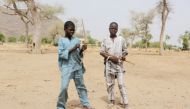Boys hold bows and arrows in Kerawa, Cameroon, March 16, 2016. REUTERS/Joe Penney