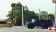 Ivorian armed police officers stand aboard a vehicle in a street of Bouake, yesterday.