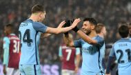 Manchester City's Argentinian striker Sergio Aguero (3rd R) celebrates with Manchester City's English defender John Stones after scoring their fourth goal during the English FA cup third round football match between West Ham United and Manchester City at 