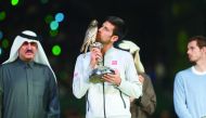Serbia's Novak Djokovic poses with the ExxonMobil Qatar Open trophy after beating Britain's Andy Murray 6-3, 5-7, 6-4 in the final at the Khalifa International Tennis Complex in Doha yesterday